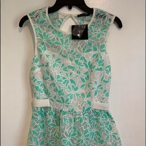 Green and white appliqué floral peplum top size S